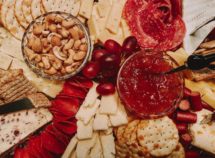 Charcuterie Board with Brie, Italian Sausages, Jam, Cashews and Grapes Recipe