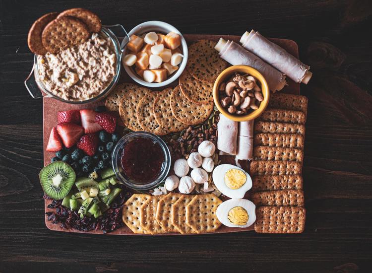 Charcturie Board with Artisan Crackers, Hummus, Kiwi, Hard Boiled Eggs, Berries