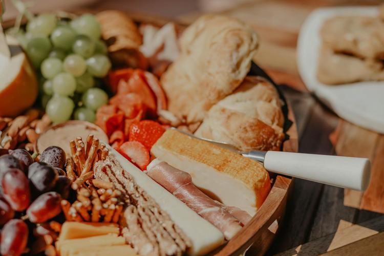 Charcuterie Recipe - Picnic Charcuterie Board with Grapes, Pretzels, Cheese, Baguette and Berries