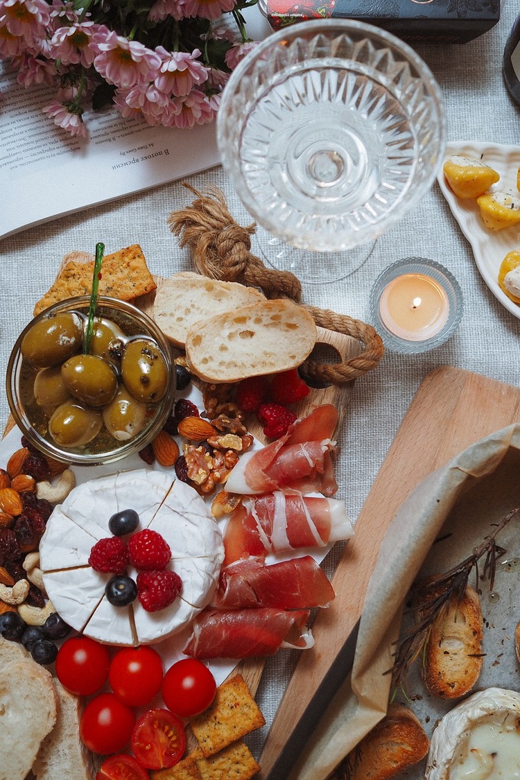 Appetizer Charcuterie Board with Brie Cheese, Cashews, Cherry Tomatoes and Olives