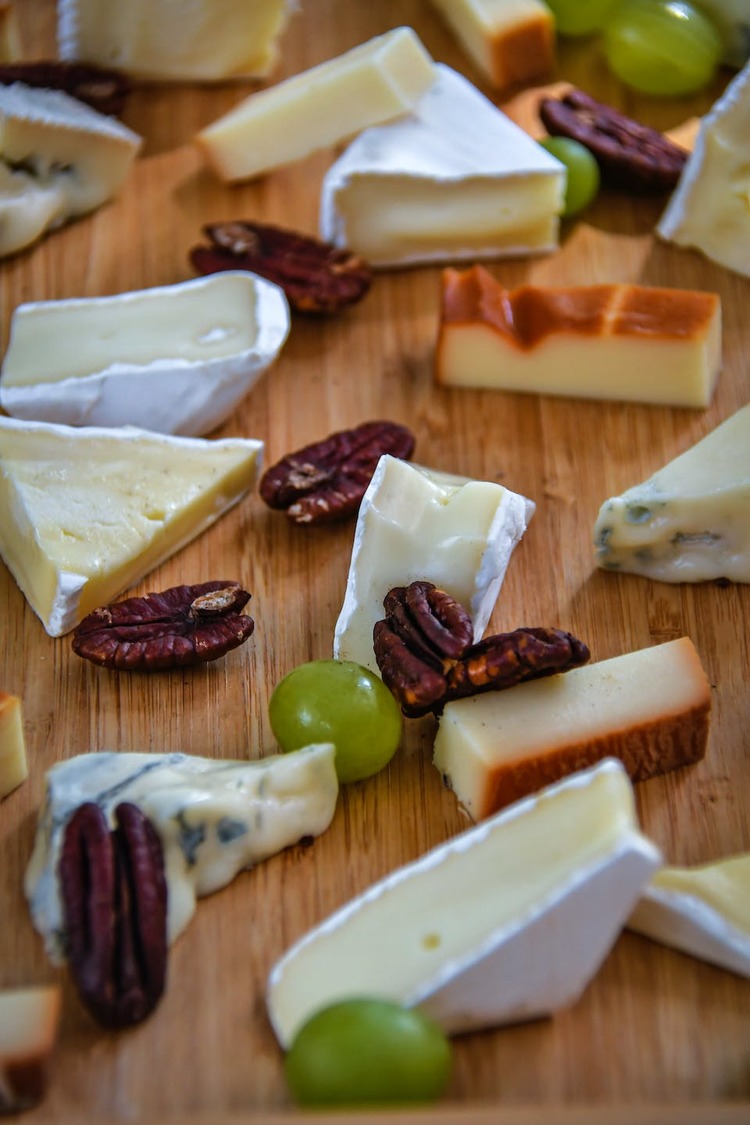 Assorted Brie and Romano Cheese Board with Walnuts and Grapes Recipe